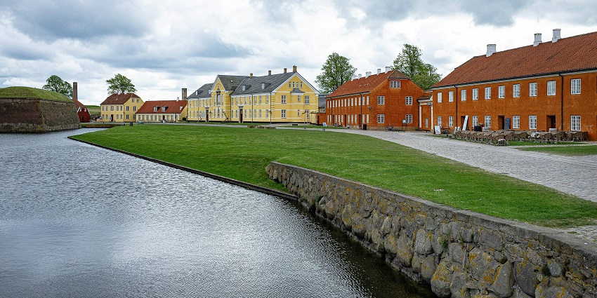 An image of Helsingor, a waterfront town with colourful buildings and a church.