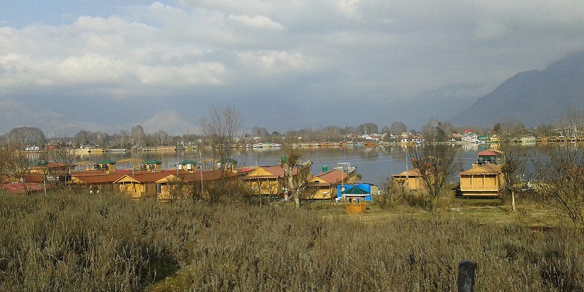 A beautifully decorated type of houseboat in Srinagar Dal Lake with intricate wood carvings.
