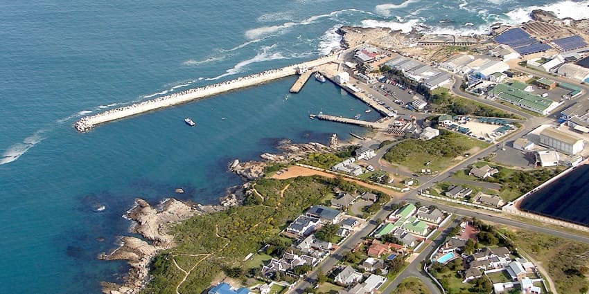 Aerial view of New Harbour in Hermanus, South Africa showing the sea, roads and houses