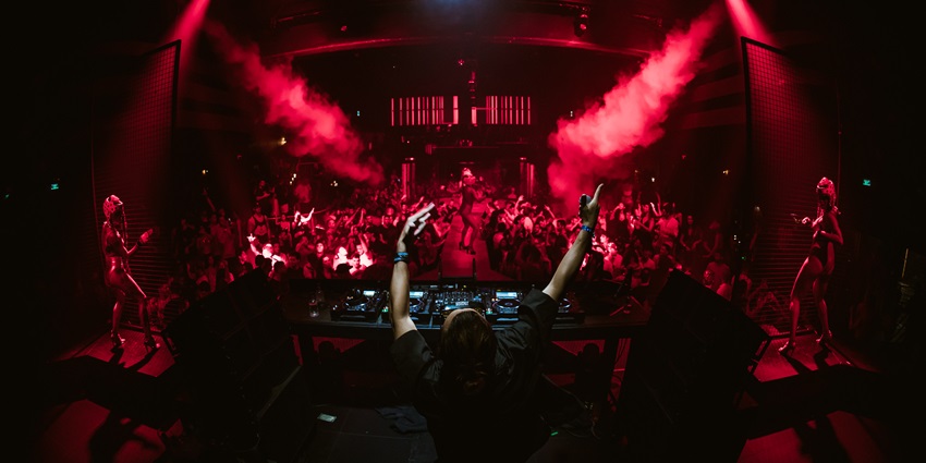 A famous DJ performing at Hï Ibiza, pushing the nightlife experience to the best version