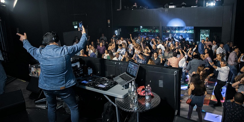 An image of a crowd moving to the beat, creating a vibrant atmosphere in High Spirits.