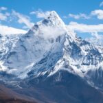 Ama Dablam mountain with snow-covered slopes and rocky ridges against a blue sky