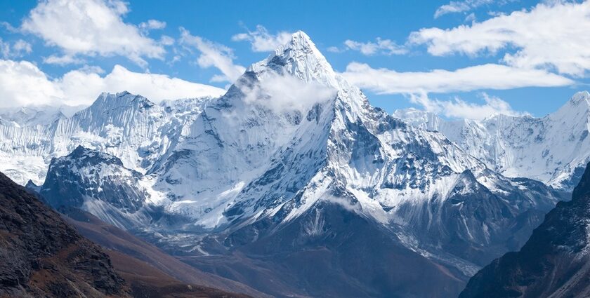 Ama Dablam mountain with snow-covered slopes and rocky ridges against a blue sky