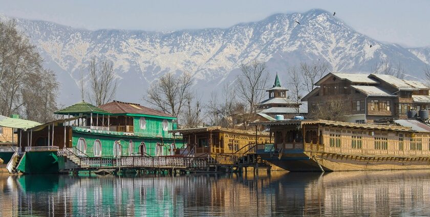 An image of a houseboat on Dal Lake in Srinagar, Kashmir- hill stations in India with snowfall.