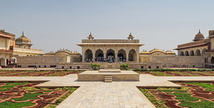 An image of the red sandstone walls and moat of the Agra Fort, one of the most famous historical forts in India.