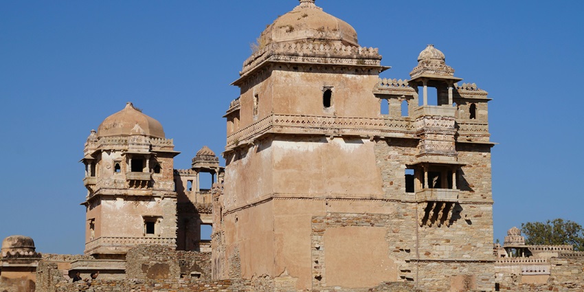 An image of the Chittorgarh fort with domed towers and intricate stone architecture