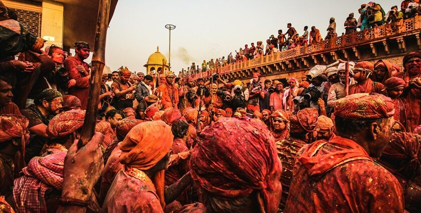 A sea of colour drenched people during Holi Mahostav at Radha Krishna Temple in Vrindavan.