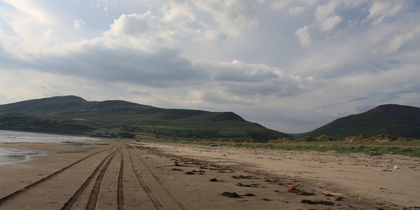 An image showing Inch Beach in Ireland, with scenic views of the coastline and waves.