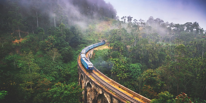 Ella nine arch bridge with surrounding area in the Sri Lanka, with Udarata Menike train on it.