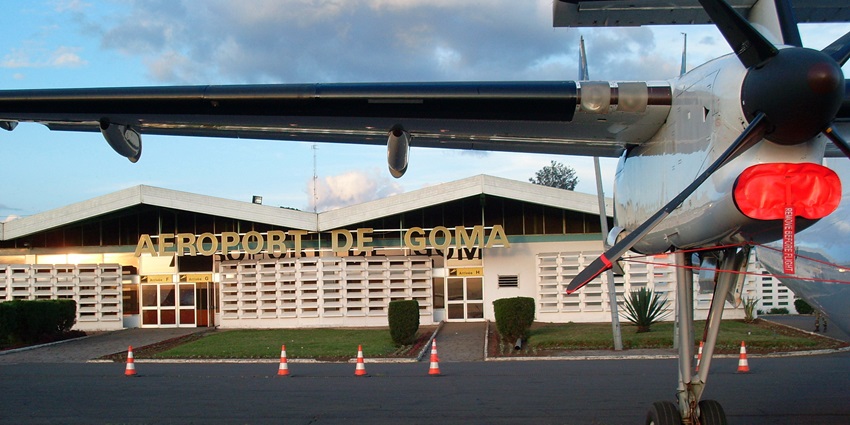 Goma International Airport (GOM) with aircraft, terminal, and surrounding scenery.
