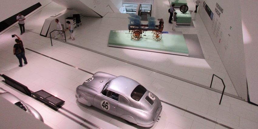 An image showing the interior of the Porsche Museum, featuring sleek exhibits and displays.