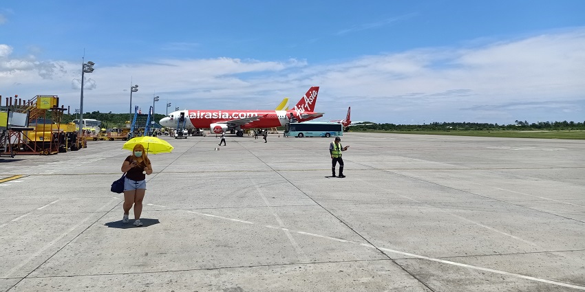 Image of an airport and employees working on ground The nearest airport to Boracay Island is Caticlan Airport