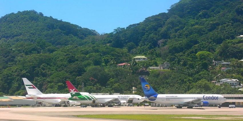 Several airplanes from different airlines parked at Seychelles International Airport