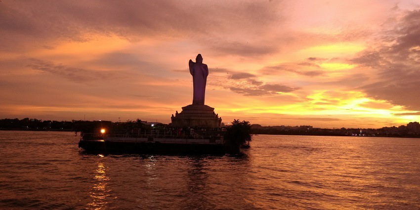 Aerial view of one of the artificial lakes in India with a Buddha statue in the middle of the water