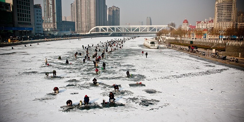 Image of people enjoying on the frozen River resembling Hwacheon Sancheoneo Ice Festival