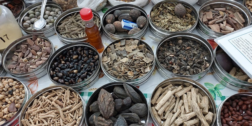 Different jars of Ayurvedic healing medicines with a spoon.