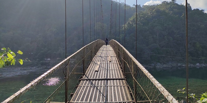 A nature enthusiast capturing the scenic beauty of Meghalaya’s cleanest lake on the bridge.