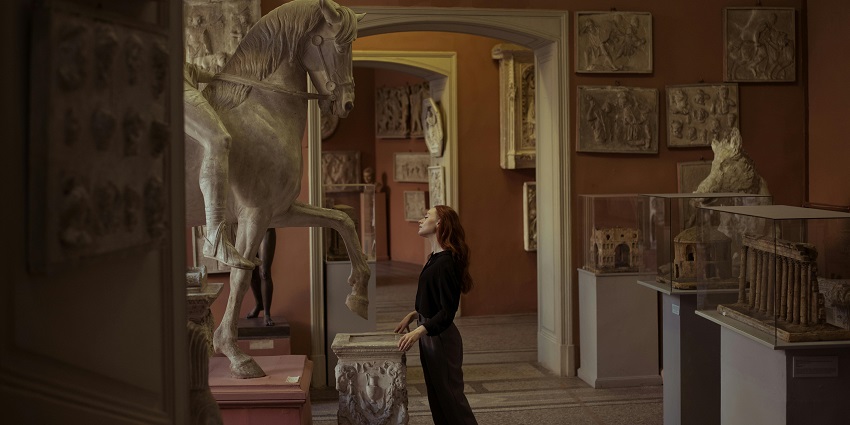 An Image of a woman admiring the paintings in the London museum.