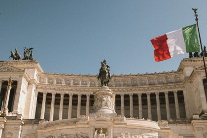 An image of the Monument to Victor Emmanuel II in Rome, Italy, with Italian flags flying.