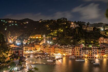 An image of Night view of Portofino, Italy, with illuminated buildings and harbor