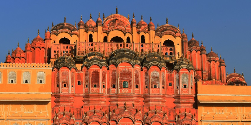 An image of Hawa Mahal, a five-story palace in Jaipur, made of red and pink sandstone, one of the popular places to visit in January in north India.