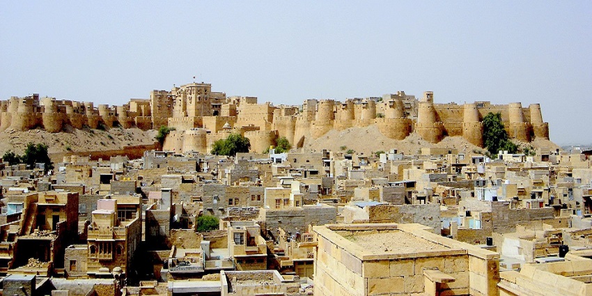 An image of Jaisalmer Fort in India, with surrounding city buildings showcasing historic architecture and citywide landscape.