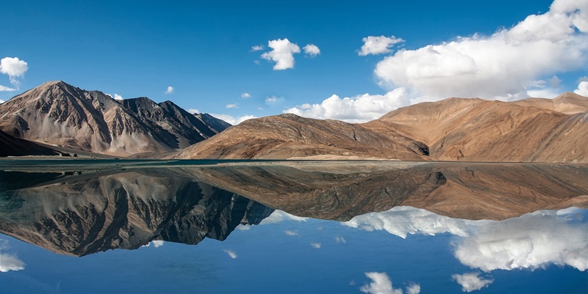 An image of mountains located in Jammu and Kashmir with rugged peaks and scenic views