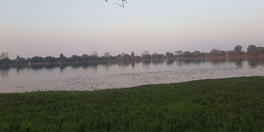 An image of Joysagar Lake, a historic man-made lake, surrounded by greenery.