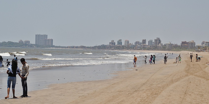 A picture of Juhu Beach with people enjoying the shoreline near Kharghar