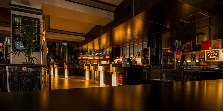 Image of empty bar filled with lights decorations and drinks on the Shelves