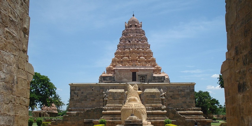 Entrance to the Lord Shiva temple with people exploring and a Nandi statue in the middle