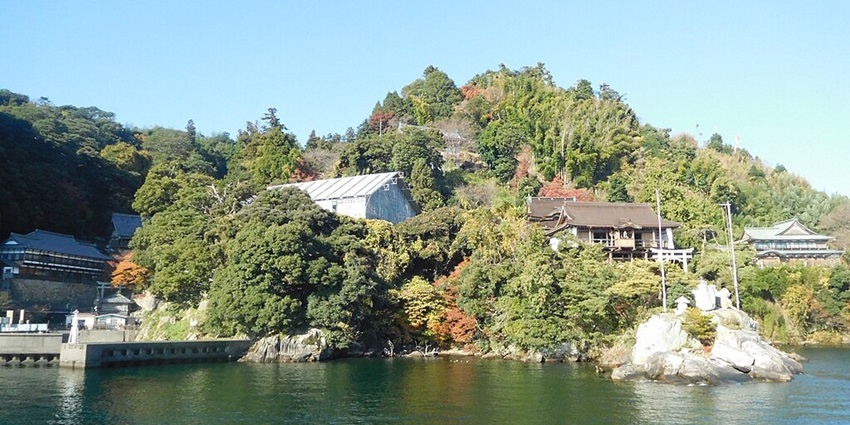 Chikubu Island with multiple traditional Japanese buildings and dense green trees.