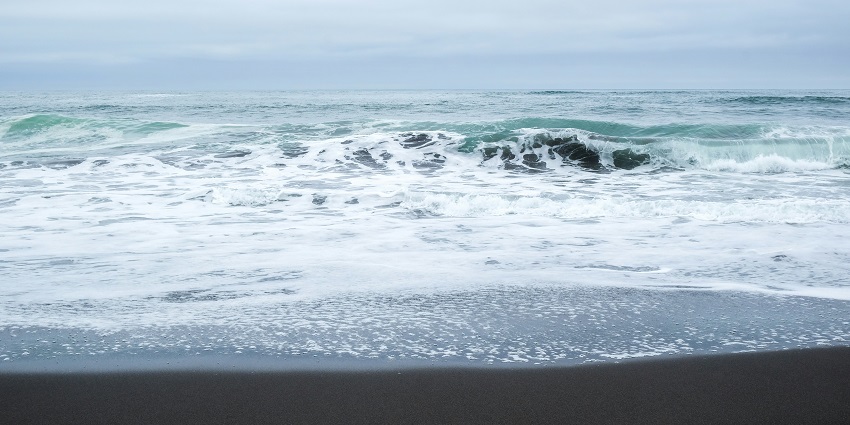 A black sand beach with Pacific Ocean views and waves, among the best beaches in Russia.