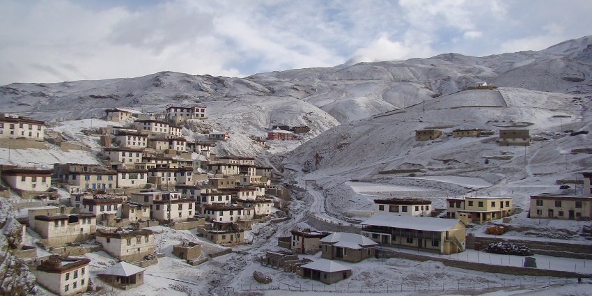 An image showing Kibber village in Spiti Valley, Himachal Pradesh, with houses on a hillside.