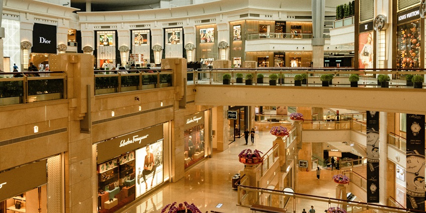 An image of a modern-style shopping mall with high-end stores and boutiques