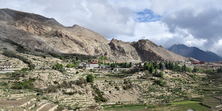 An image of the scenic Kinnaur Valley with apple orchards and Himalayan peaks.