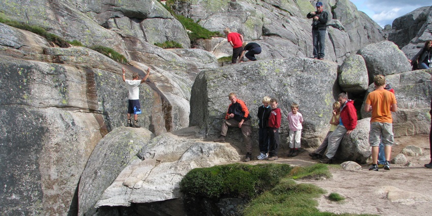 An image showing the backside of Kjeragbolten, capturing its dramatic cliffside setting