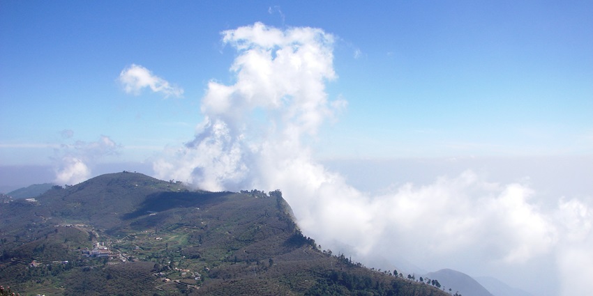 Mesmerising mountain views with clouds at a popular place to visit in June in South India