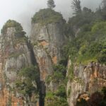 Magnificent pillars of rocks partially covered in mist in Kodaikanal, Tamil Nadu