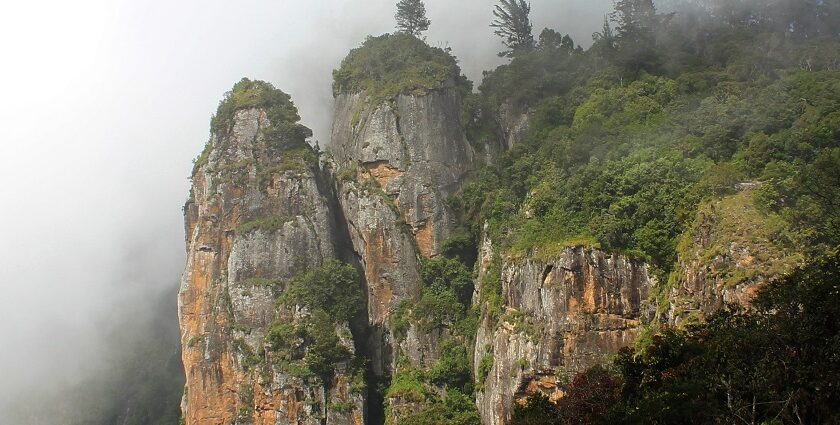 Magnificent pillars of rocks partially covered in mist in Kodaikanal, Tamil Nadu