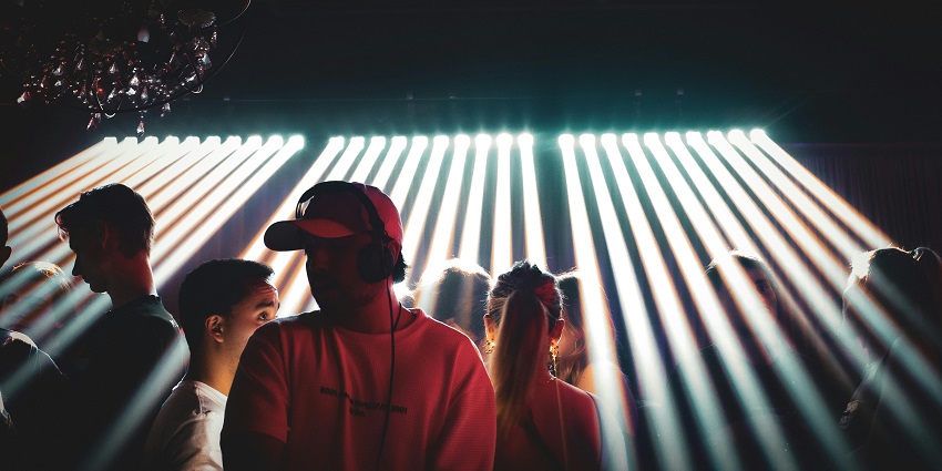 An image of people dancing to the DJ Mixer in Kolkata, showing nightlife in India.
