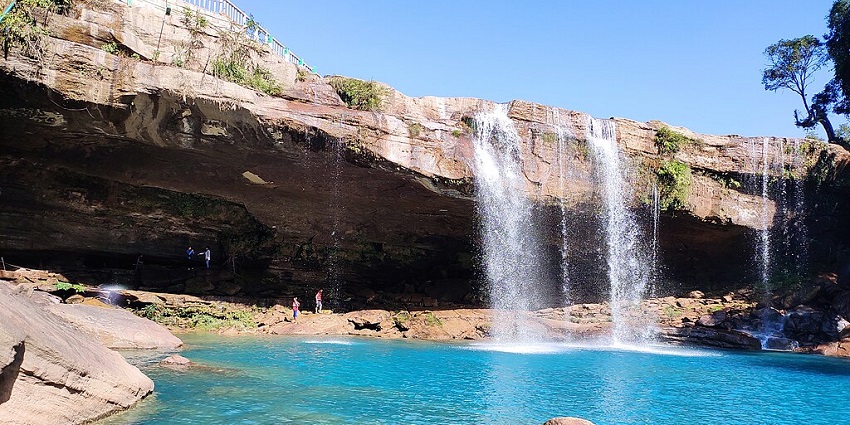 A stunning view of the Krang Suri Waterfalls, cascading into a turquoise pool.