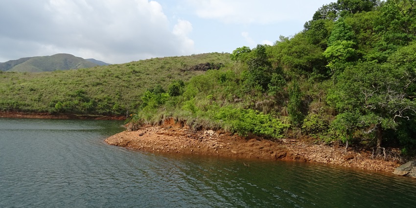 An image of Kudremukh Lakya Dam Lake in Karnataka, surrounded by lush green hills.
