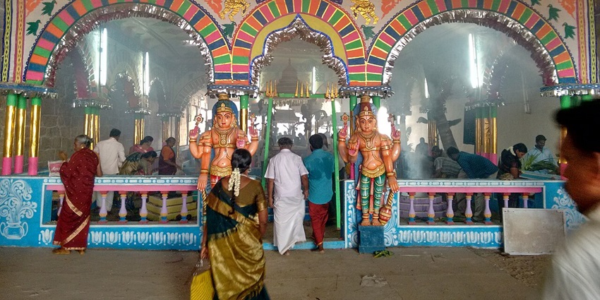 Entrance to the Kumbakonam Temple, with some devotees entering and others inside.