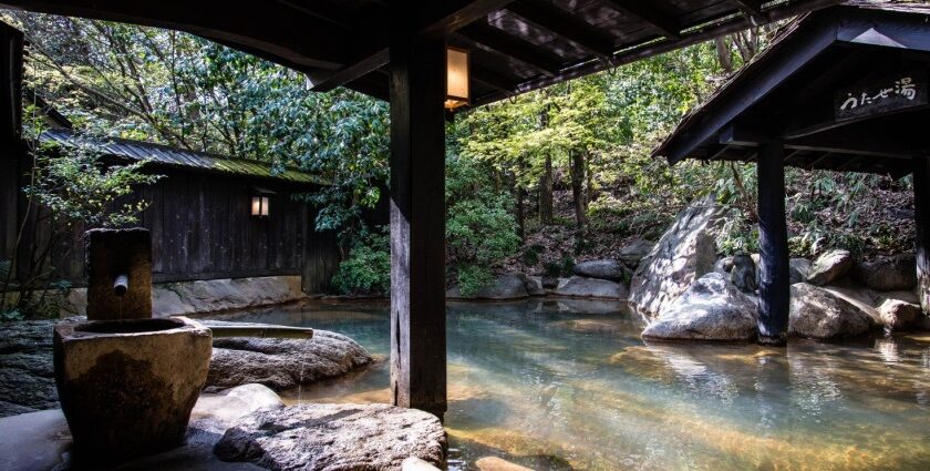 Image of hot bath at Kyoto Hot Springs, surrounded by lush greenery landscape