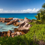 A breathtaking vista of a serene place nestled in Seychelles featuring golden beaches.