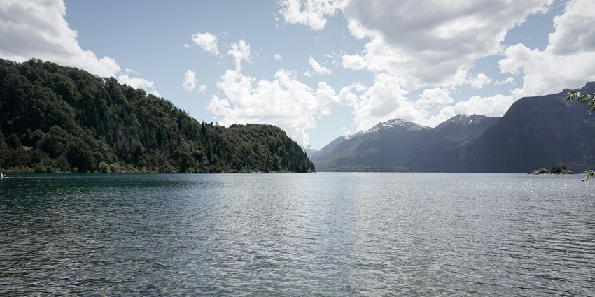 A deep blue lake stretching towards a mountain range, highlighting the lakes in South America.