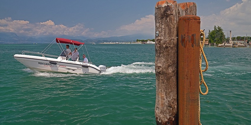 An image of Lake Garda, Italy, one of the scenic lakes in Europe, with a peaceful boat jetty.