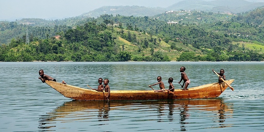 An image view of Lake Kivu in Africa with a lush green island, calm waters, and a scenic horizon