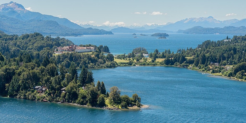 An image of the vibrant blue lake with surrounding vegetation, making it a picturesque location.